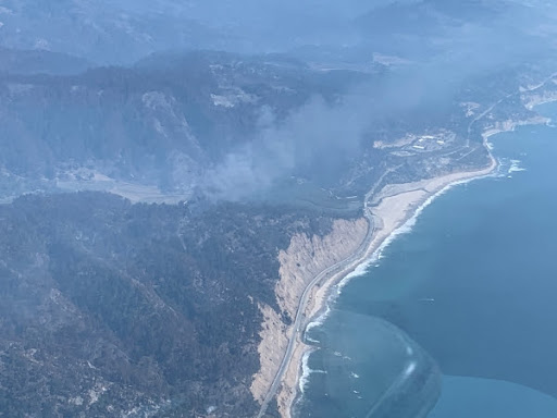A wildfire smolders along the North Coast