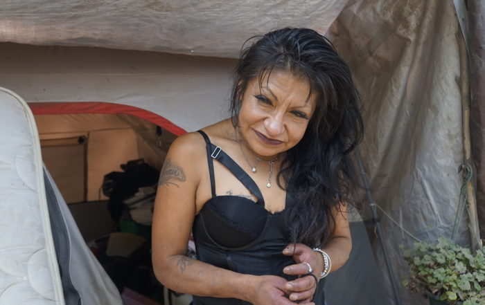Julissa Diaz stands next to her tent at Camp Paradise in Santa Cruz in September 2021