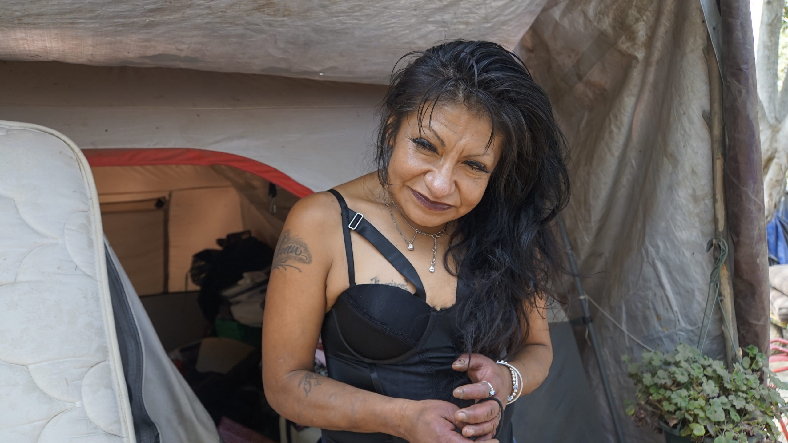 Julissa Diaz stands next to her tent at Camp Paradise in Santa Cruz in September 2021