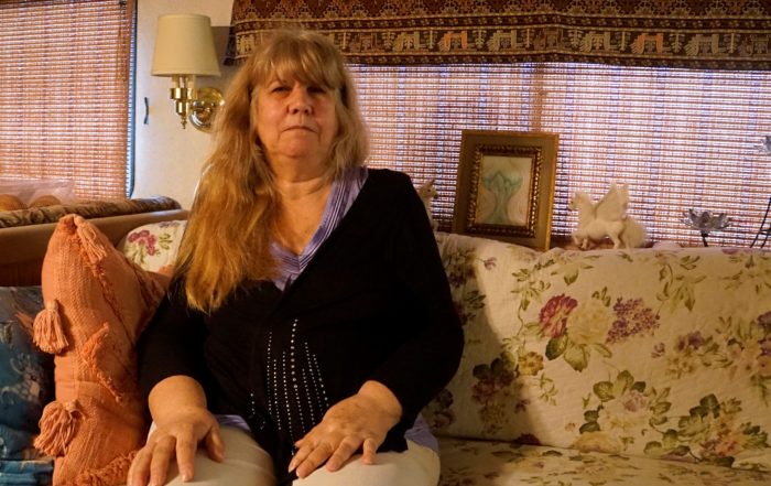 Silvana Hays sits on her couch in her RV in Santa Cruz