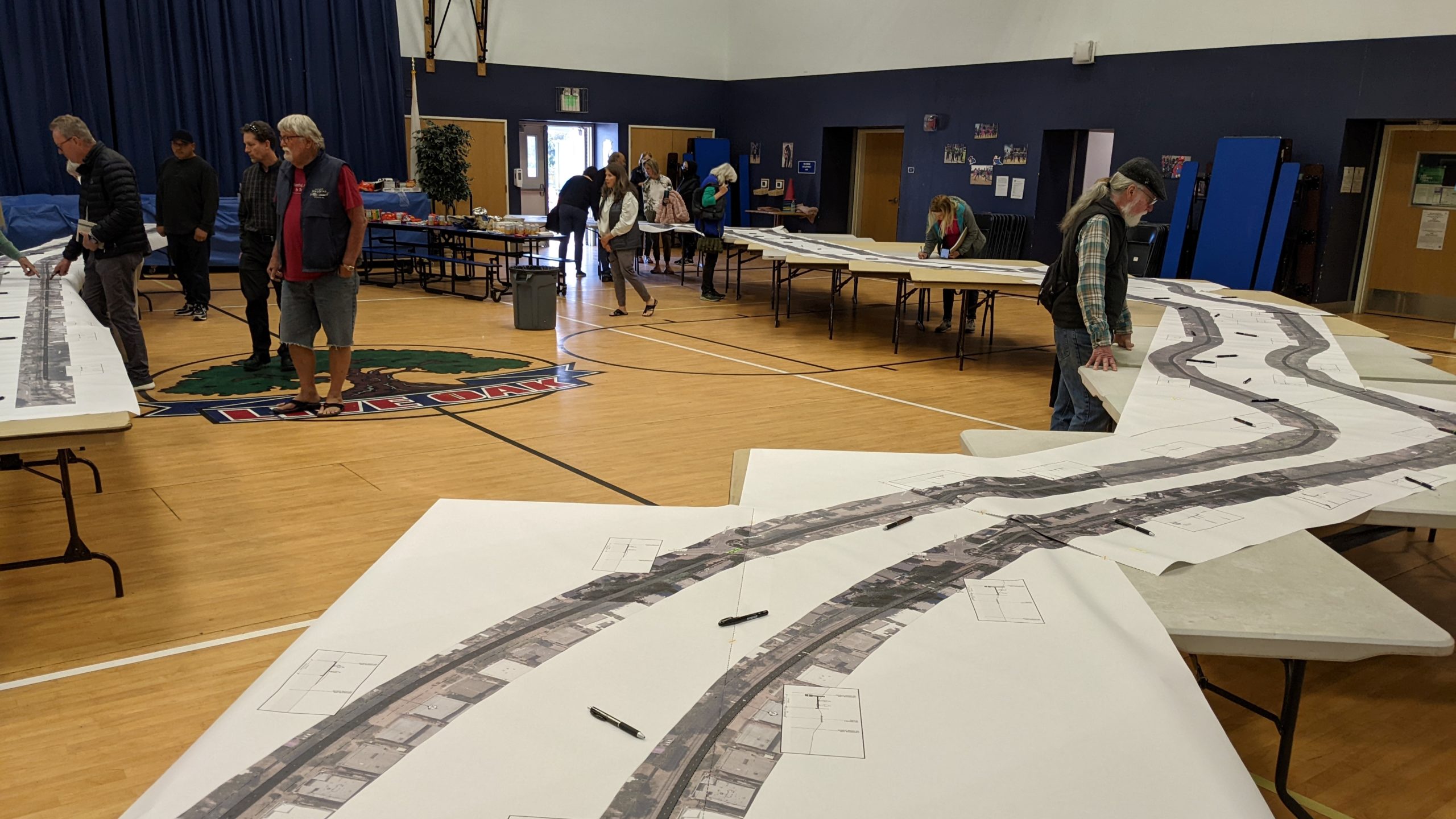 Residents view designs for “interim” and “ultimate” rail trail options at Live Oak Elementary School on April 16.