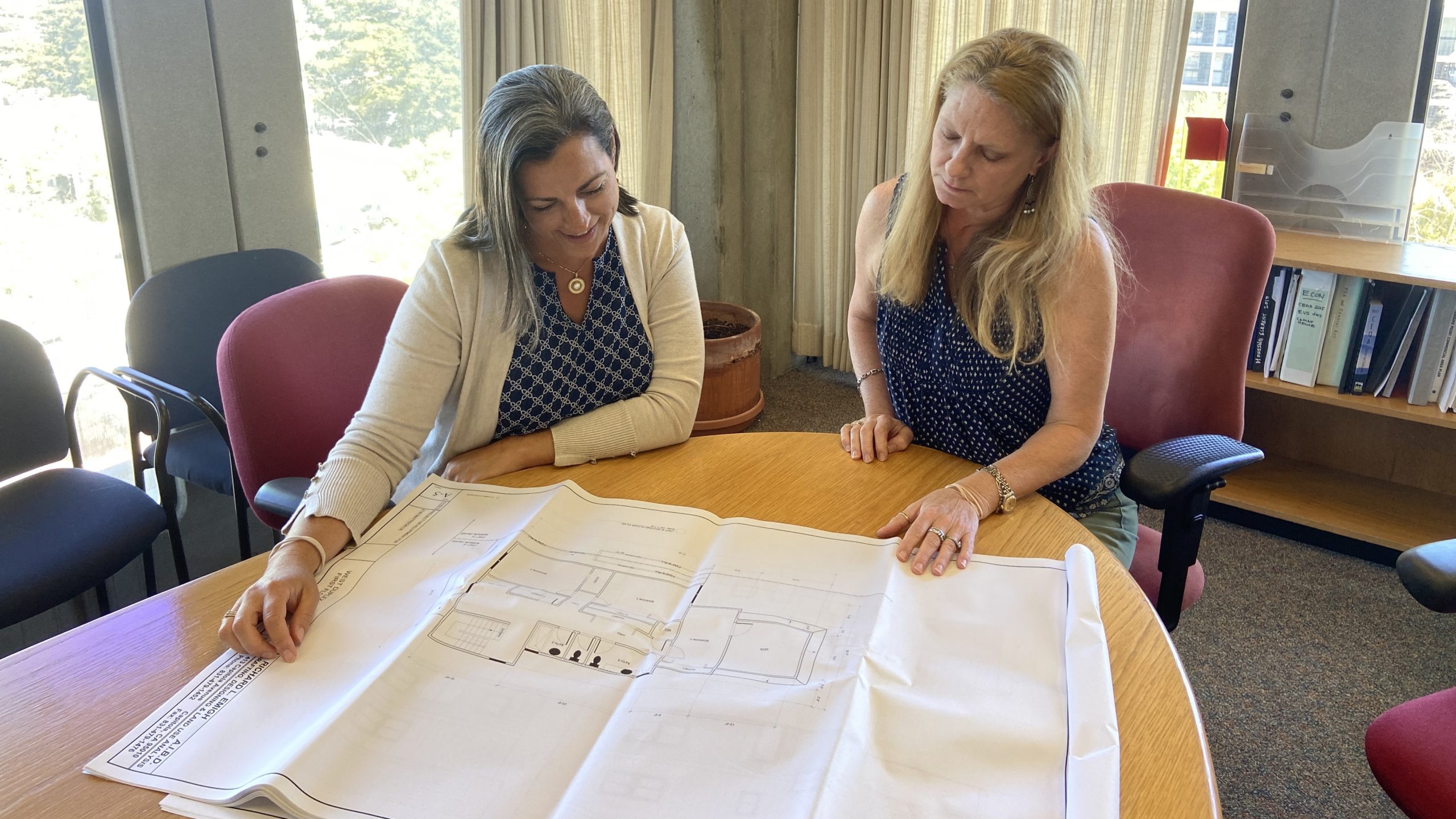 Carolyn Burke, left, is the assistant director of community development and infrastructure for the County of Santa Cruz. She looks at building plans with Santa Cruz County Principal Planner Stephanie Hansen. (Grace Stetson — Santa Cruz Local)
