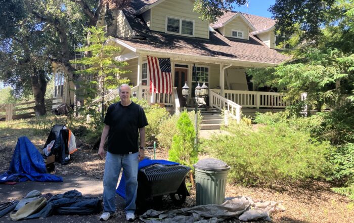 Paul Booth stnad in front of his home off Highway 17. He said his home insurance was not renewed in 2023.