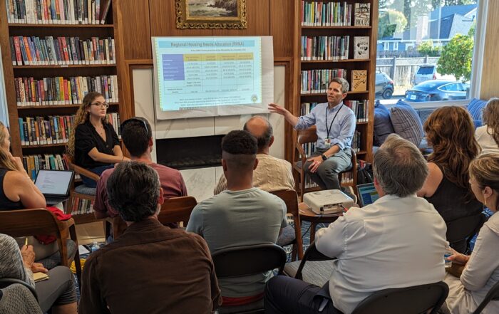 Robert Ratner sits in front of community members, speaking about solutions to homelessness at Garfield Park Branch Library in Santa Cruz on Aug. 17.
