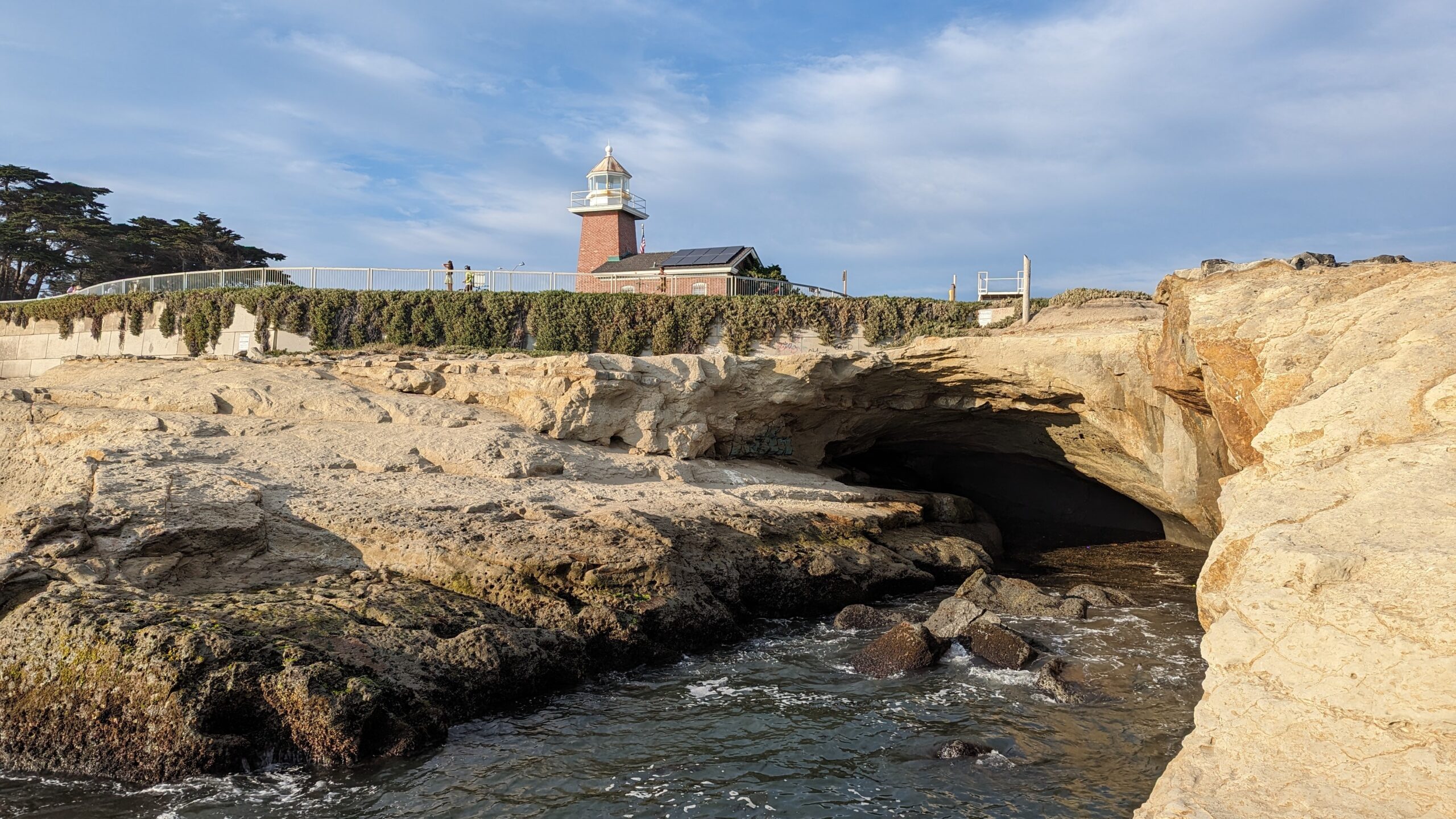 A "sea cave" is visible on West Cliff Drive below the lighthouse.