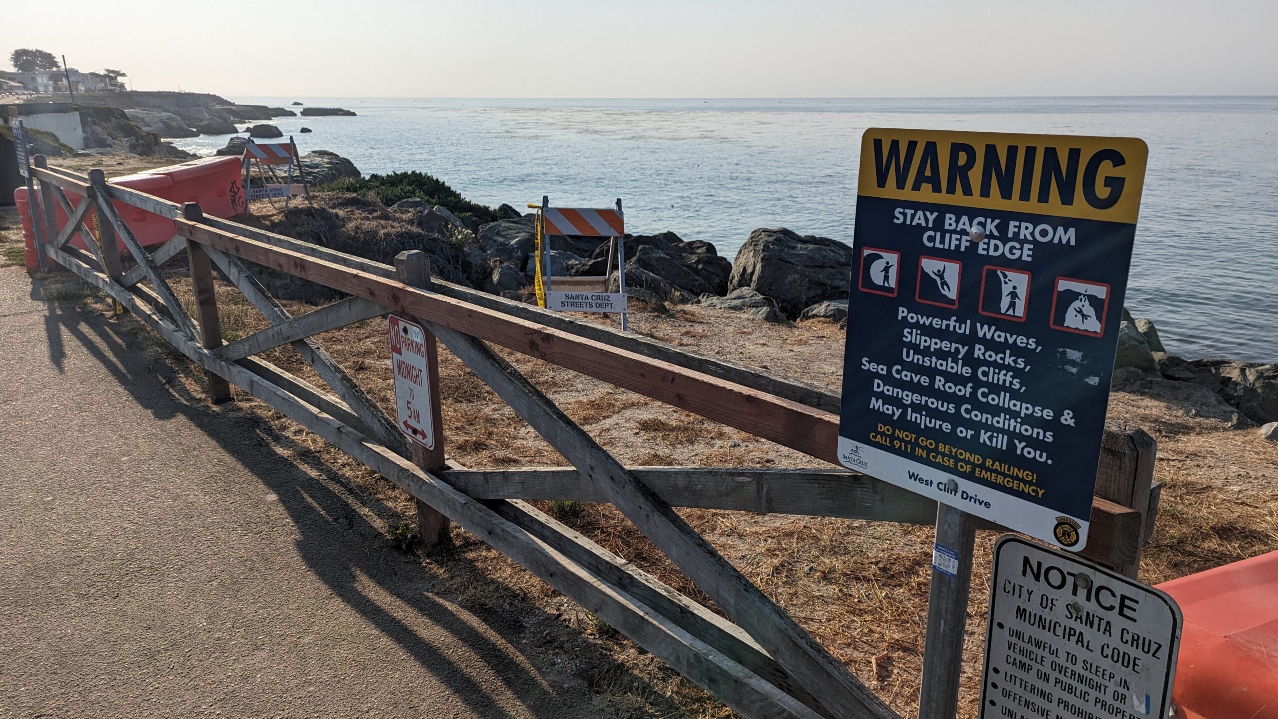 A sign on West Cliff Drive warns of unstable cliffs, slippery rocks.
