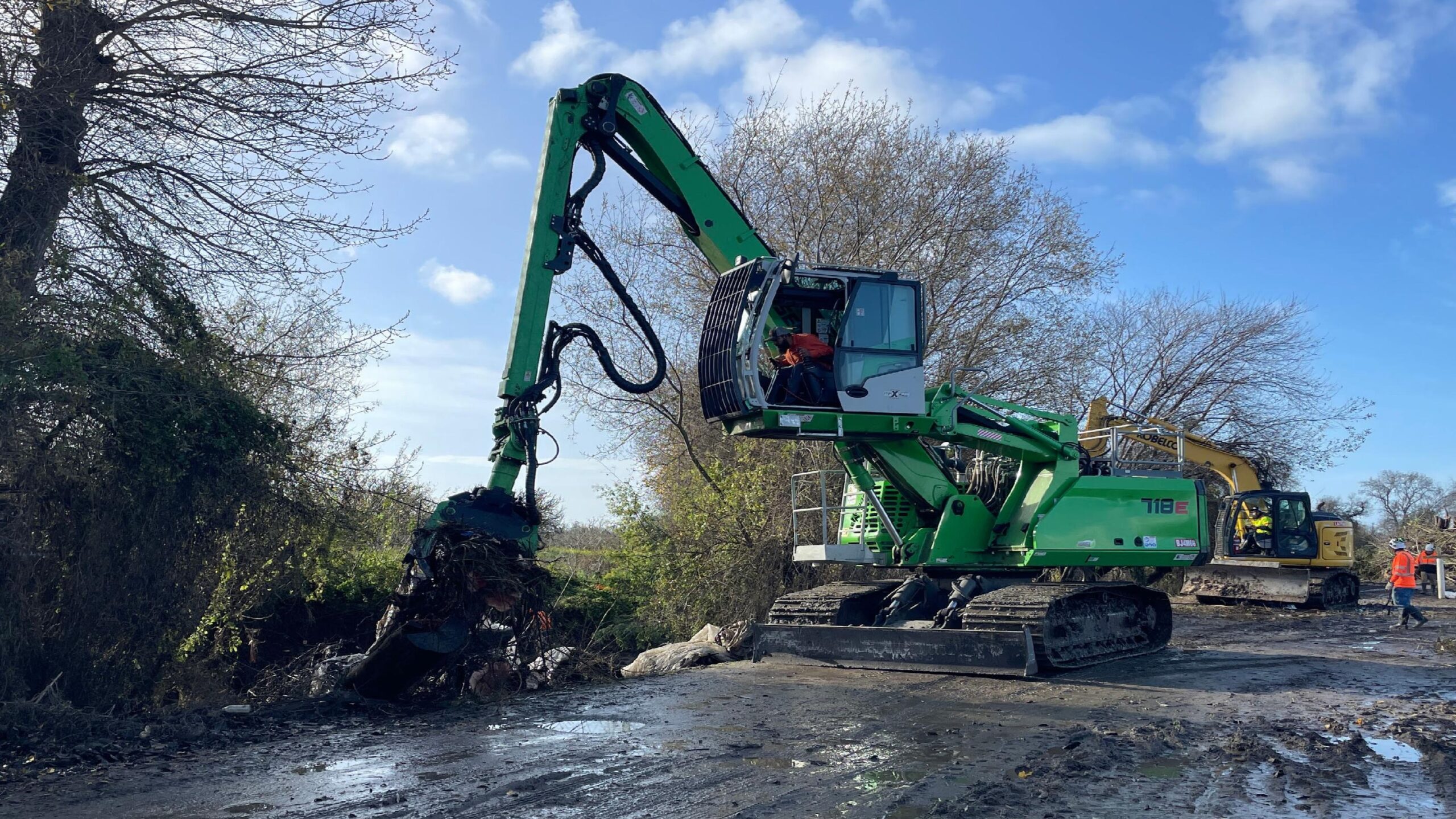 A heavy-duty machine scraped the streambed on a tributary of the Pajaro River in preparation for anticipated winter storms.