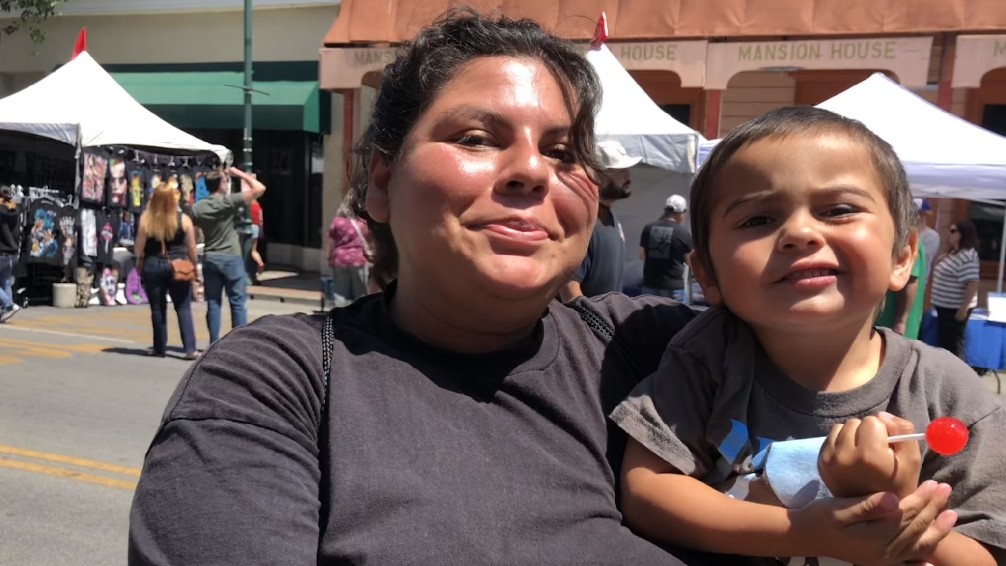 Destiny Rodrigues holds her son at the Watsonville Strawberry Festival in August 2023.