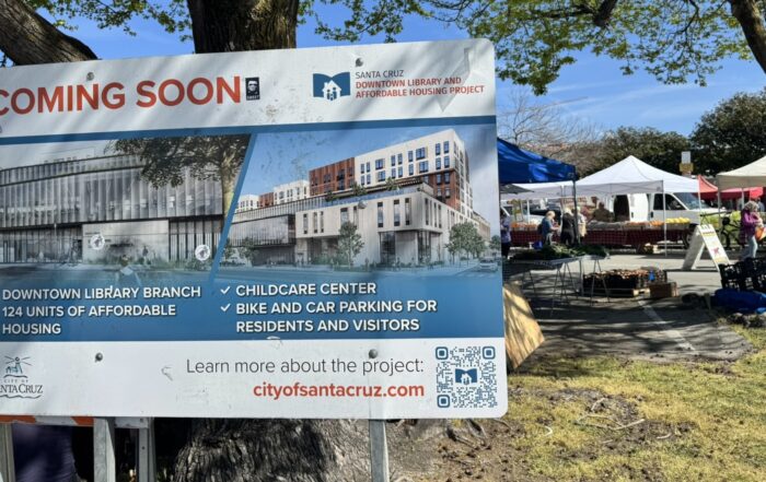 A coming soon sign in from of the farmer's market.