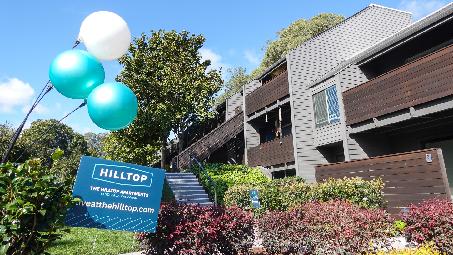 hilltop-february-2025-altenberg-4 Balloons and a sign advertise the Hilltop in front of several apartments in the complex on a sunny day in February 2025.