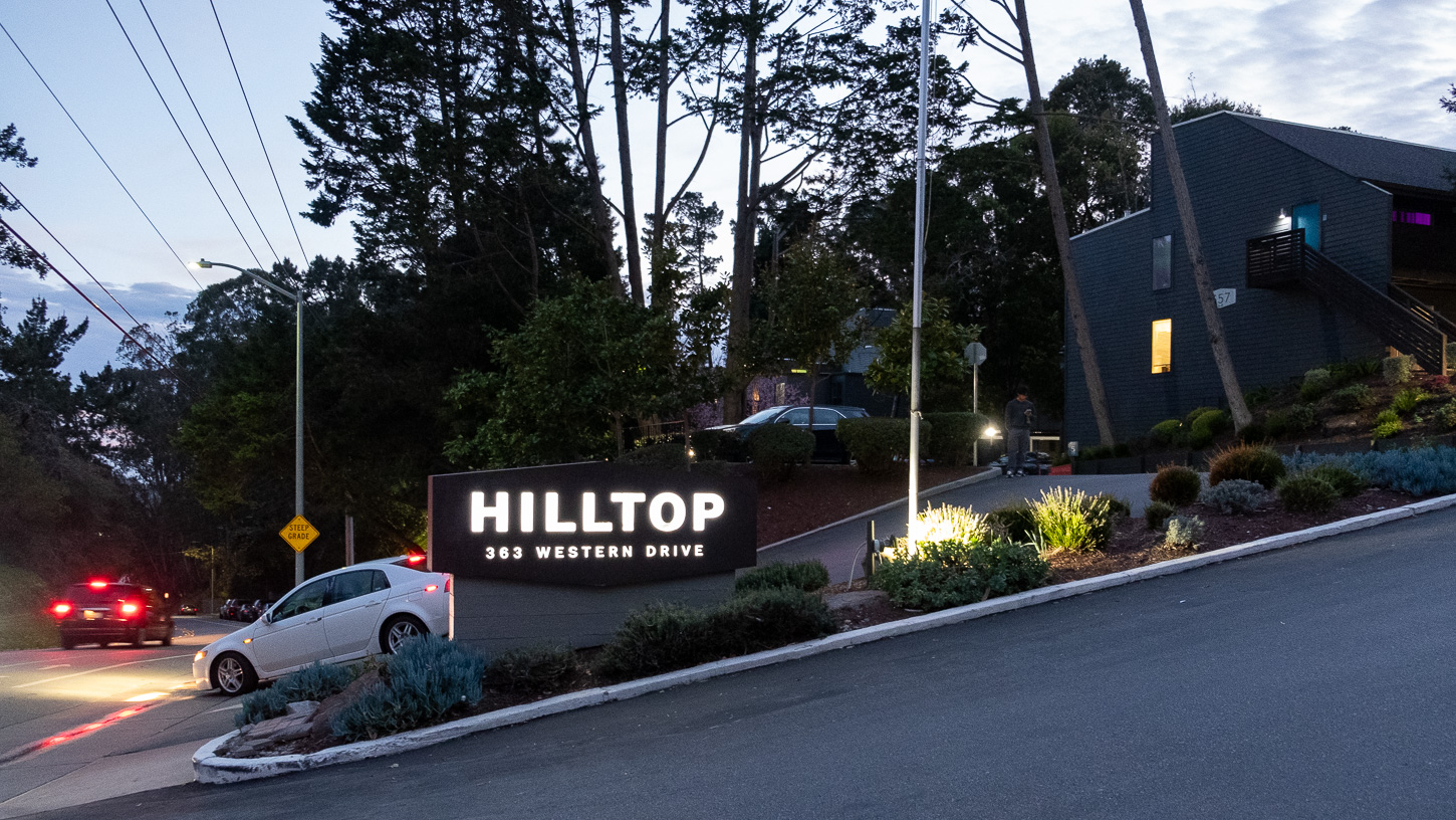 hilltop-february-2025-altenberg An illuminated sign for the Hilltop apartments in Santa Cruz is seen just after sunset in February 2025.