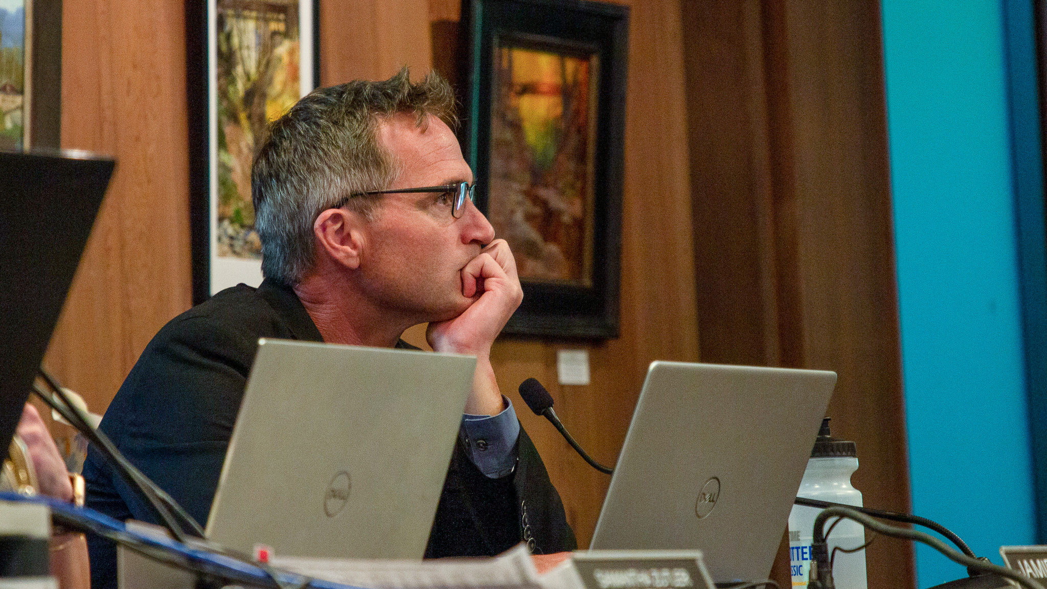 Capitola City Manager Jamie Goldstein sits with his chin resting on his hand during a city council meeting.