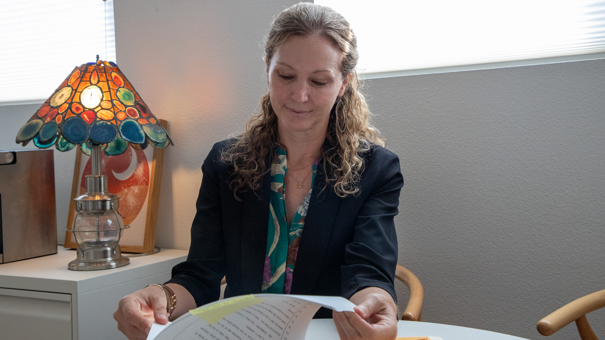 Santa Cruz County Public Defender Heather Rogers sits at her desk looking at a case file.