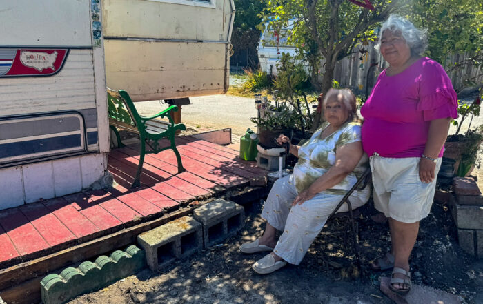 Elizabeth Lopez and her mother Leonor next to their home in Soquel Gardens mobile home park.