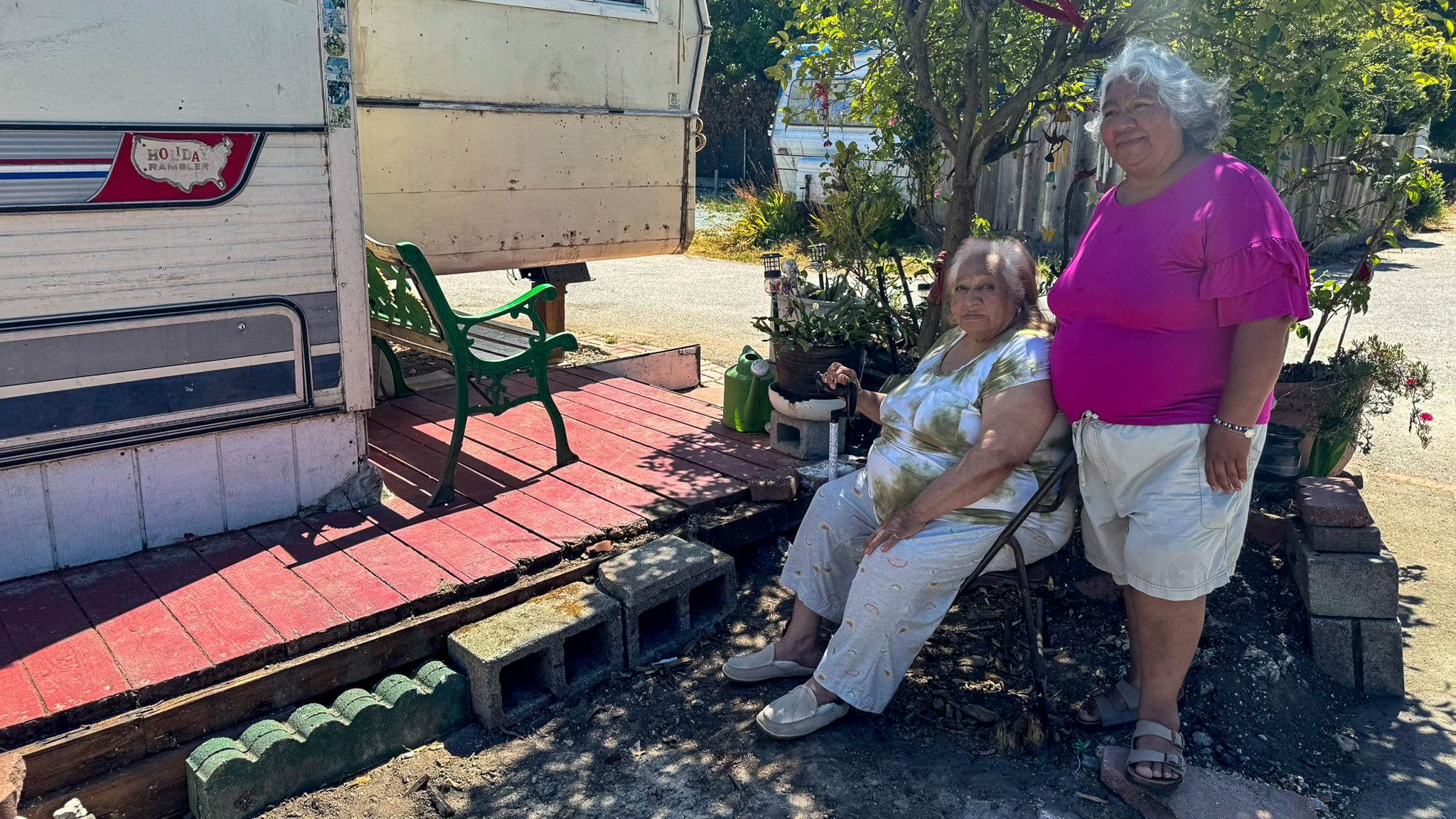 Elizabeth Lopez and her mother Leonor next to their home in Soquel Gardens mobile home park.