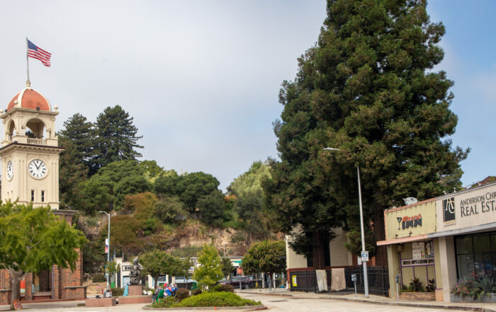 The Town Clock is seen next to the buildings on North Pacific Avenue that are slated for redevelopment into an eight-story apartment building.